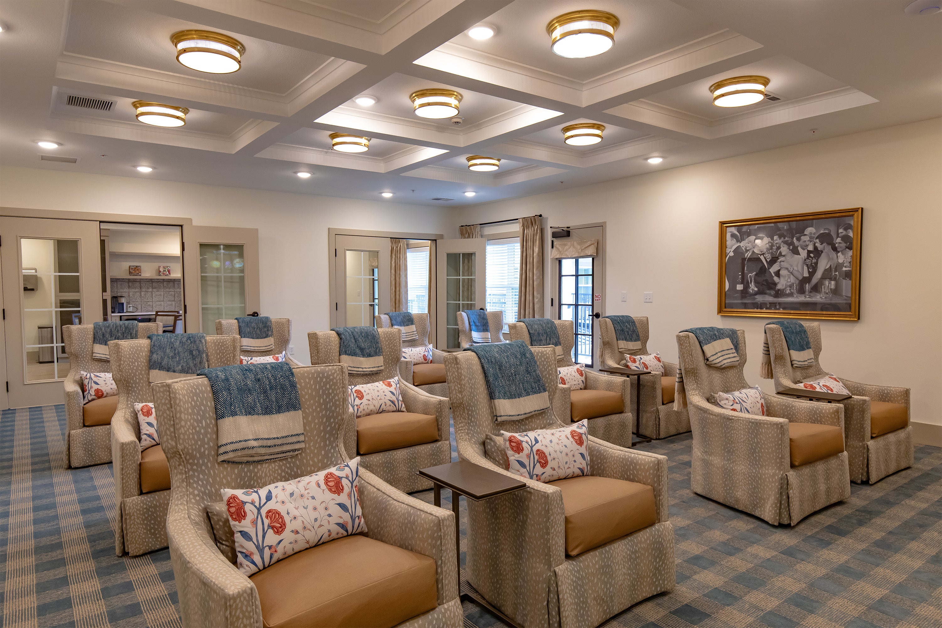 Living room with armchairs, coffee table, and decorative pillows in a home setting.