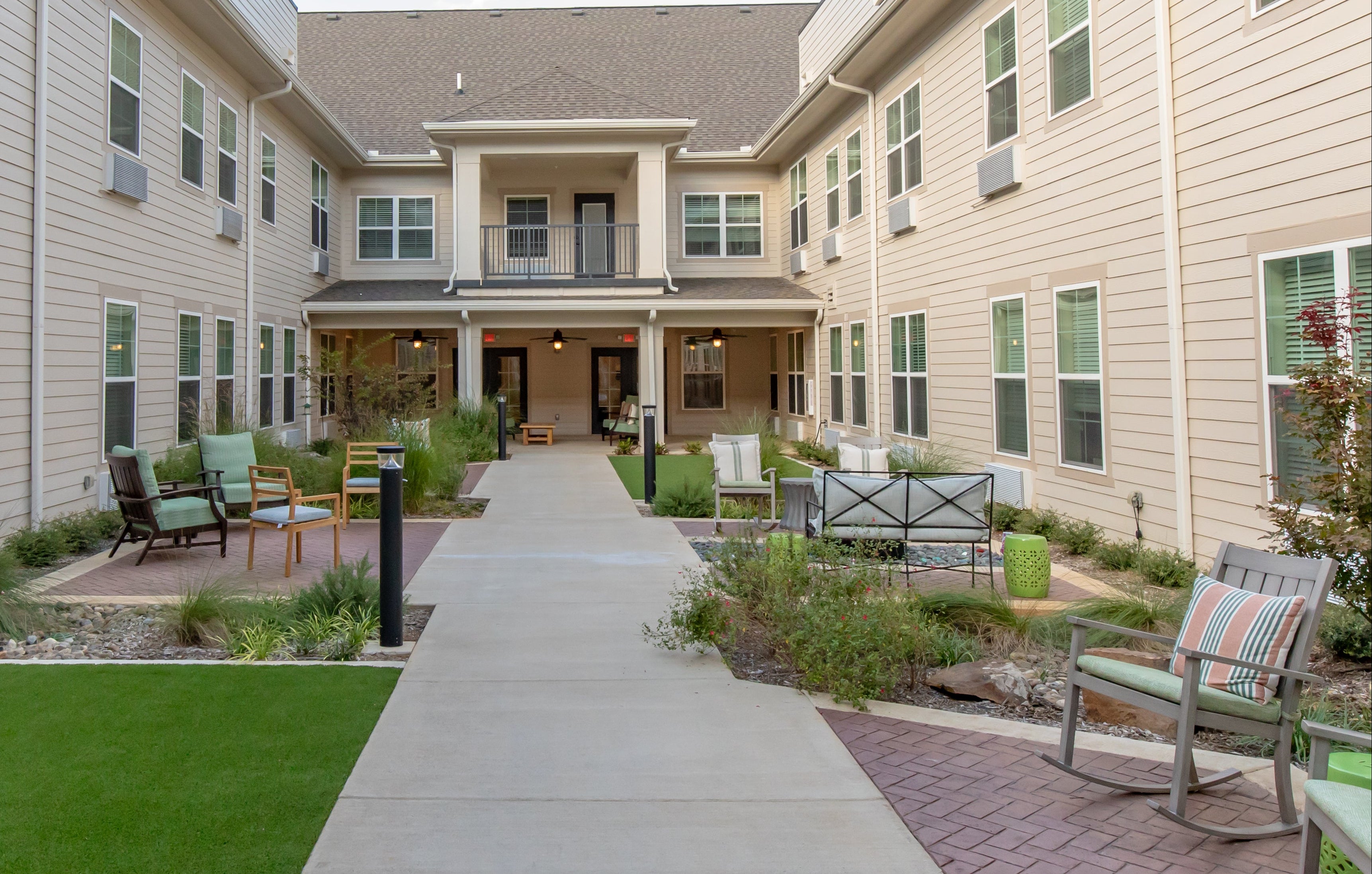Residential complex with outdoor seating area and pathway