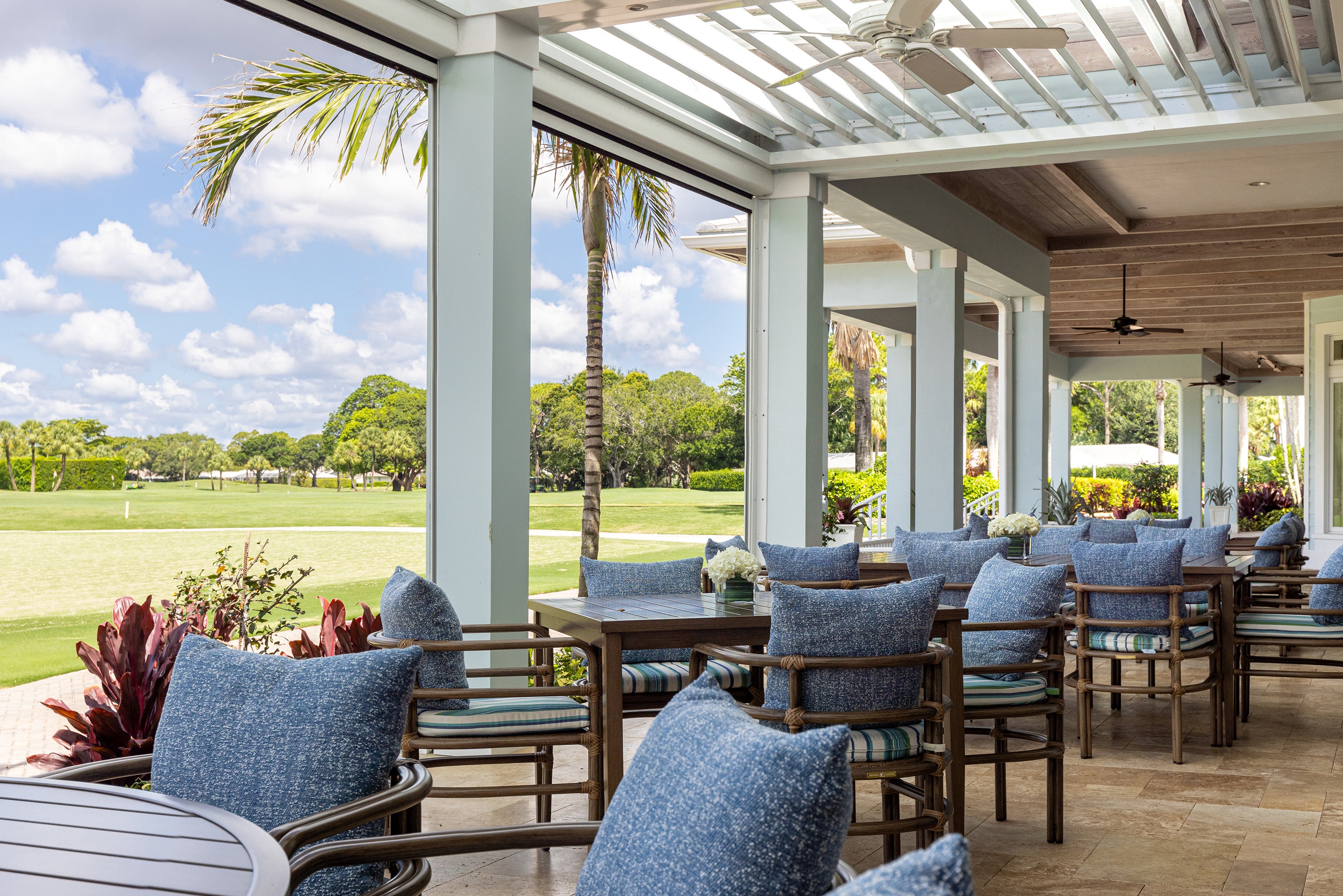 Outdoor patio area with tables and chairs on a sunny day